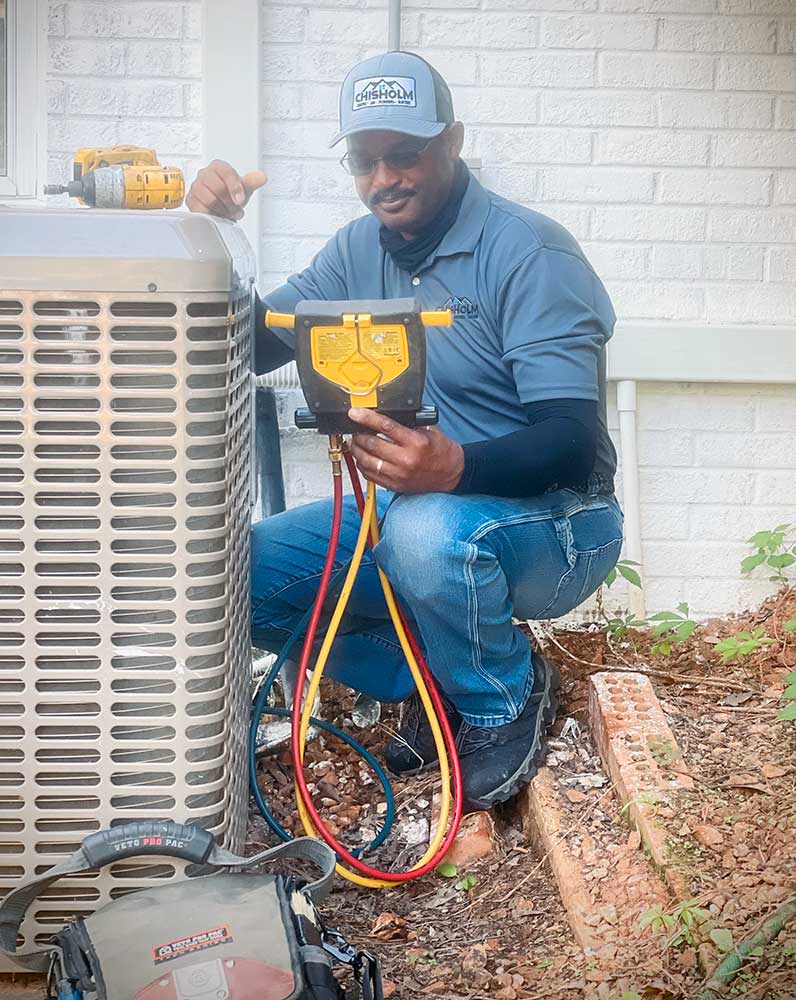 Our air conditioning repair man fixing outdoor condenser unit