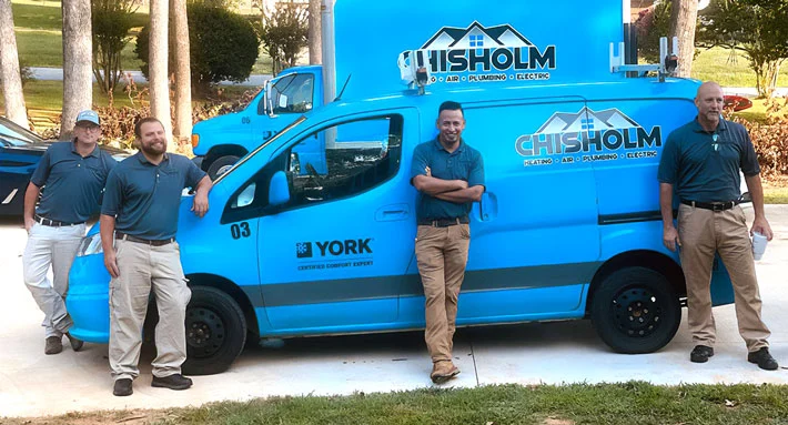 Friendly technicians by Chisholm branded service truck